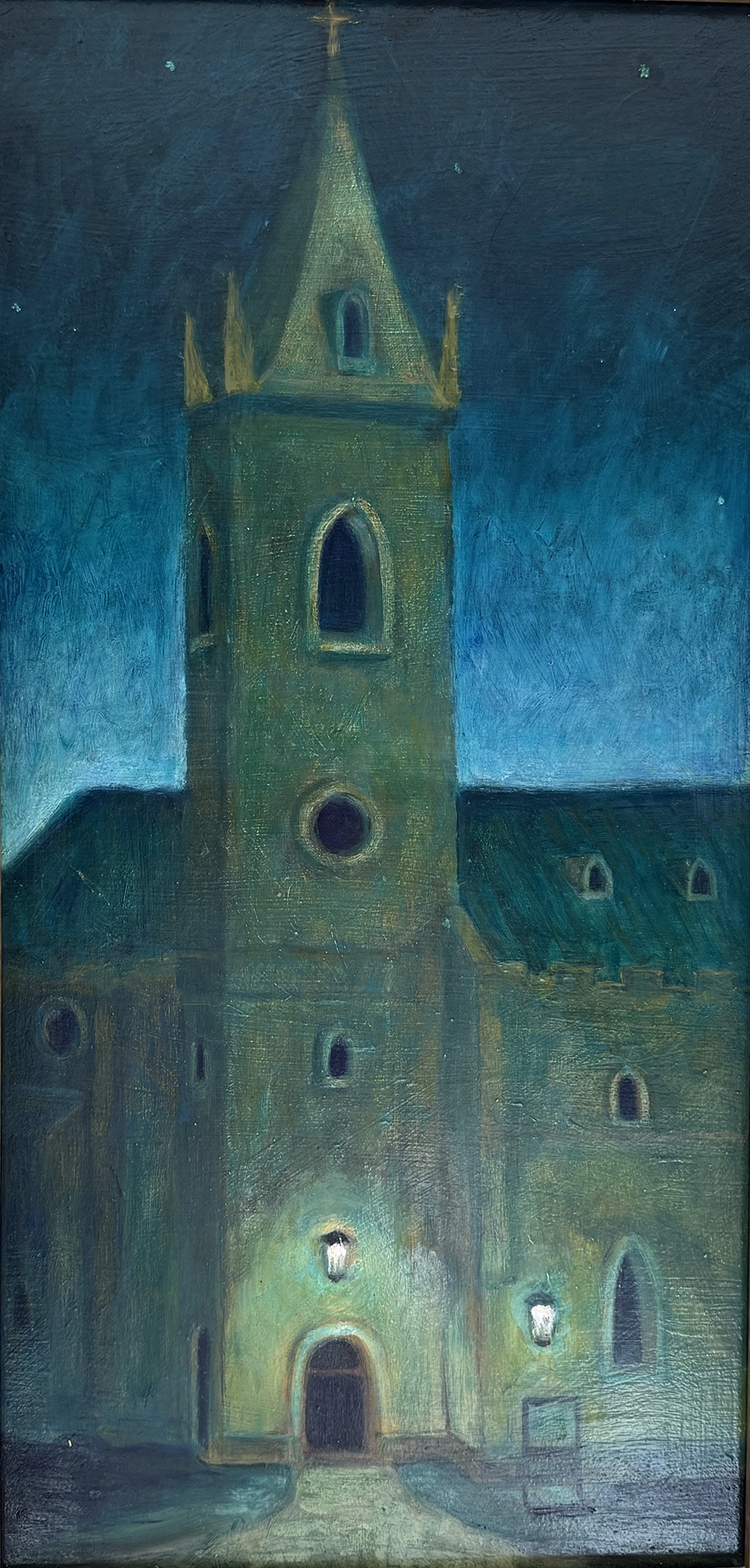 Illuminated Church Front of church lit at night by a small light at door.