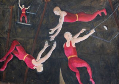 Four acrobats flying around a circus tent on trapezes