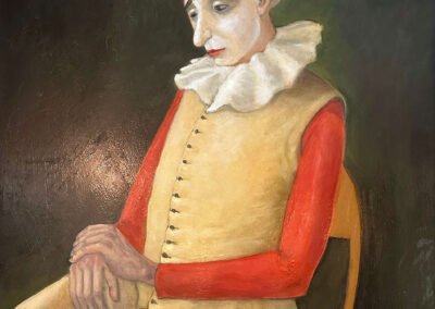 Sad clown in old-fashioned costume sitting on chair with crossed legs and hands on knee